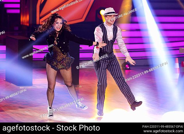 11 March 2022, North Rhine-Westphalia, Cologne: Mike Singer, singer, and Christina Luft, professional dancer, dance in the RTL dance show ""Let's Dance"" at the...