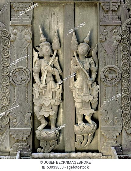 Carved figures on a teak wood door, Shwe In Bin Kyaung Monastery