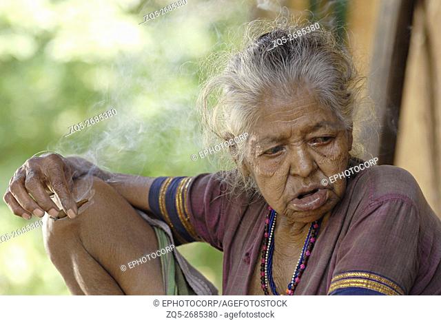 Closeup of a Warli Tribal Old Woman bidi, an Indian handmade cigarette made of tobacco or beedi leaves