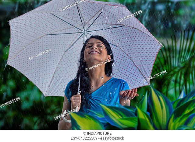 Woman enjoying in the rain