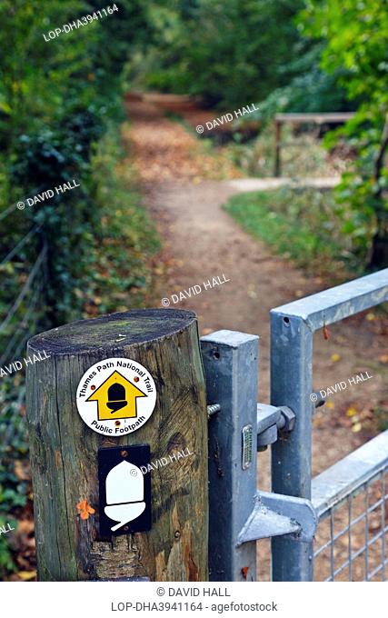 England, Gloucestershire, near Ashton Keynes. Thames Path National Trail sign on a wooden gatepost indicating the direction of the public footpath