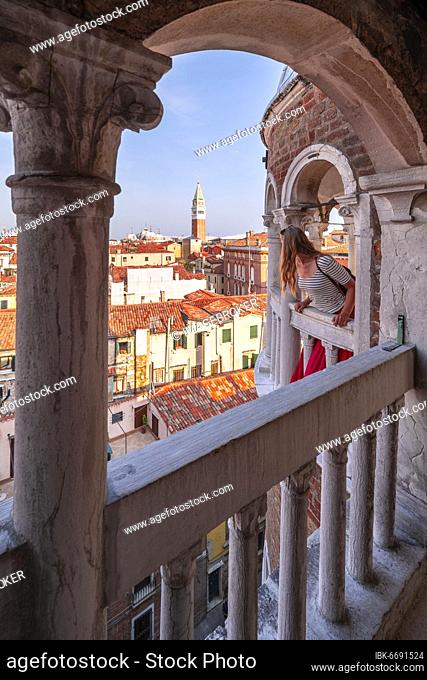 Young woman, tourist looking over Venice, dome of Palazzo Contarini del Bovolo, palace with spiral staircase, Venice, Veneto, Italy, Europe