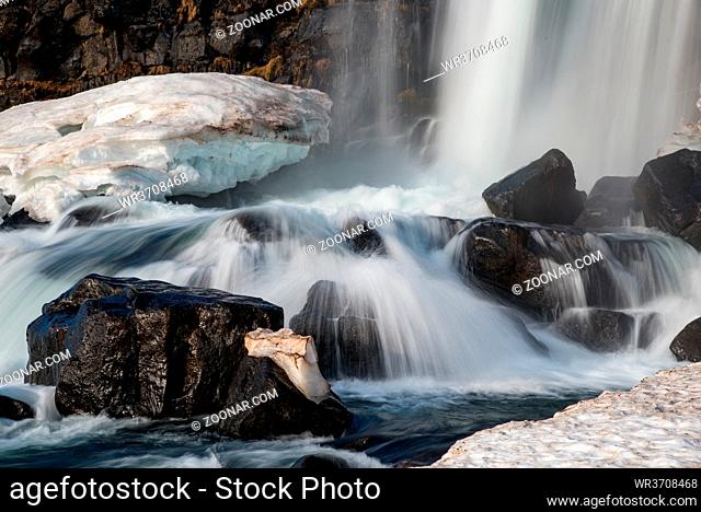 Water from waterfall splashing on a rocky river. The Oxararfoss waterfall in pingvellir Thingvellir national Park iceland