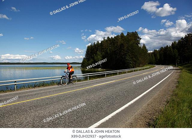 Finland, Region of Southern Savonia, Savonlinna, Punkaharju Nature Reserve, Saimaa Lake District, Lake Puruvesi, Highway Number 14, Lake, Cyclist