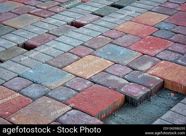 construction of brick paved sidewalk, half built pavement road