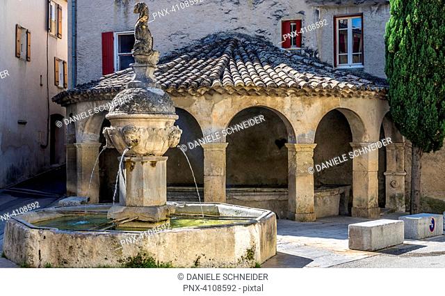 France, Drome, The Provencal Baronnies Regional Natural Park, Mollans-sur-Ouveze, Dolphin fountain (18th century) and covered semicircular wash house (19th...
