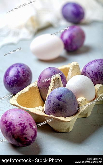 Naturally colored eggs prepared for Easter. Happy Easter card. Naturally colored Easter eggs lying in the tray, selective focus