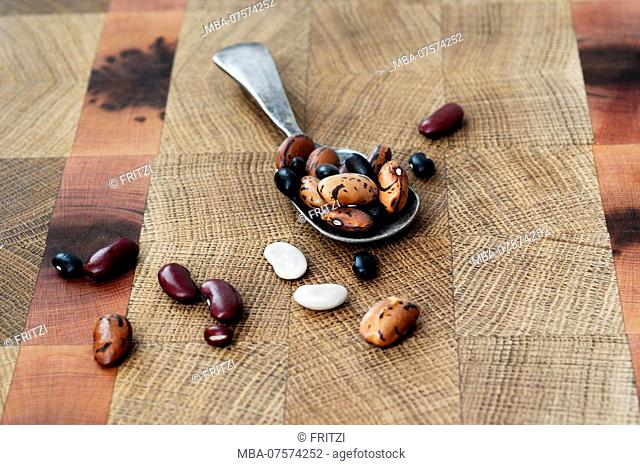 Beans, mixed beans, legumes, wooden board, spoon
