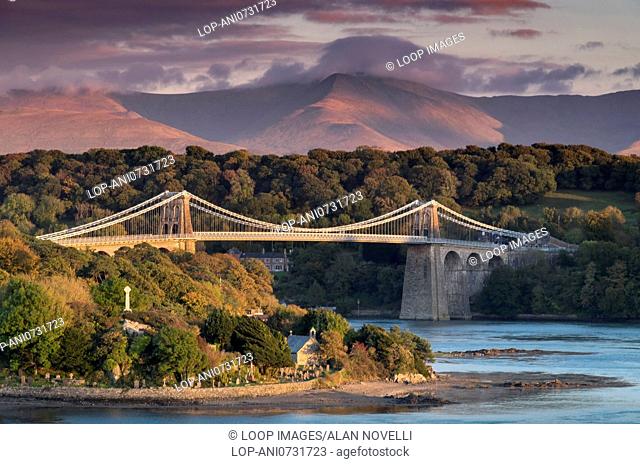 Menai Bridge over the Menai Strait backed by the mountains of Snowdonia in North Wales