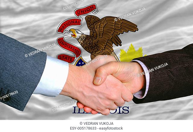 in front of american state flag of illinois two businessmen hand