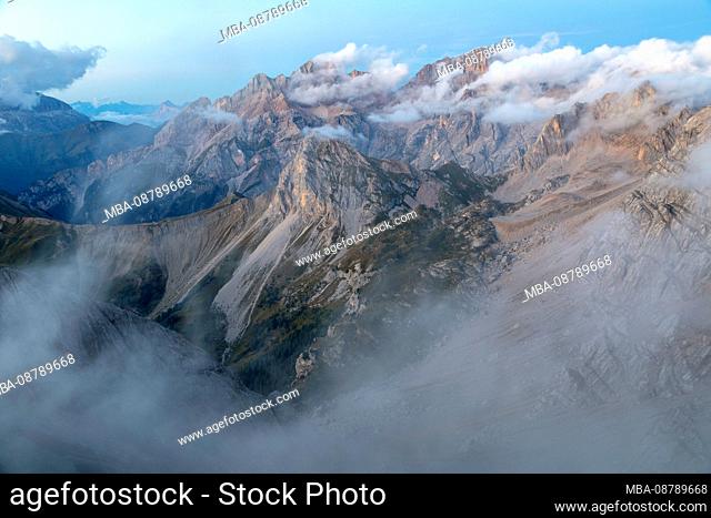 A cloudy dusk on Marmolada group seen from the summit of Cima di Costabella, Costabella Ridge, Marmolada group, Dolomites, Fassa Valley, Trento province
