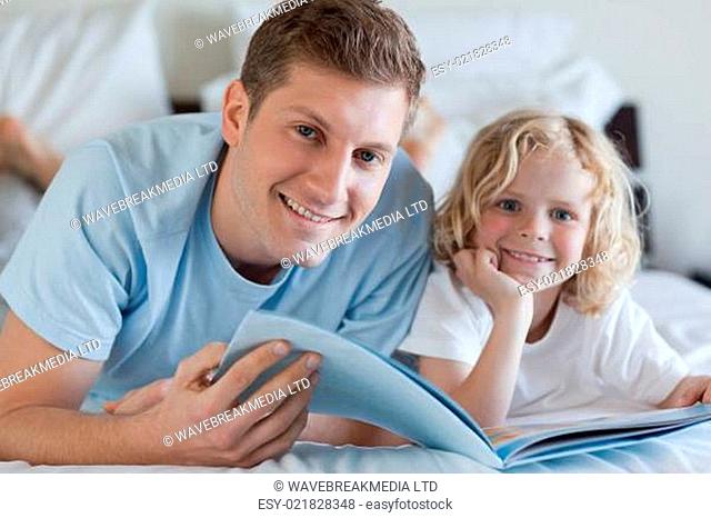 Father and son looking at magazine