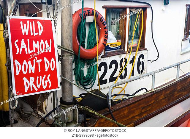 Sign pointing to the benefits of eating wild Salmon and not buying farmed Salmon