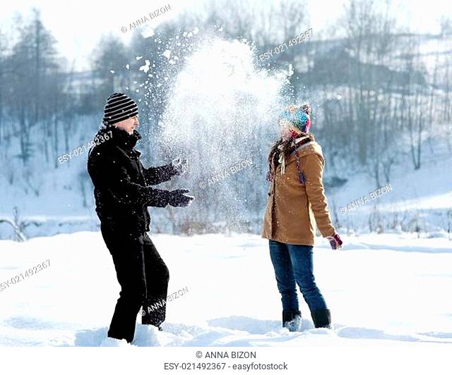Young couple playing with snow