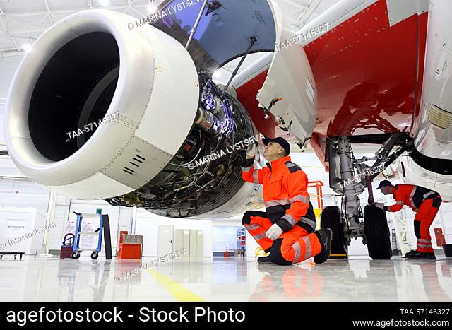 RUSSIA, MOSCOW REGION - FEBRUARY 1, 2023: Employees run a check on a Sukhoi Superjet 100 (SSJ100) aircraft's landing gear and engines at a maintenance hangar of...