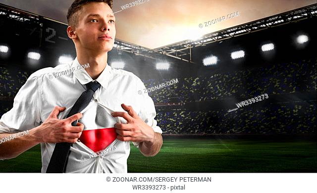 Poland soccer or football supporter showing flag under his business shirt on stadium
