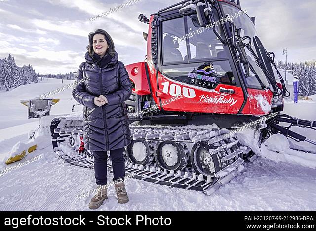 07 December 2023, Bavaria, Reit im Winkl: Bavaria's Minister of Agriculture Michaela Kaniber (CSU) stands in front of a snow groomer at the opening of the ski...