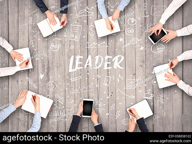 Group of business people working in office with LEADER inscription, coworking concept