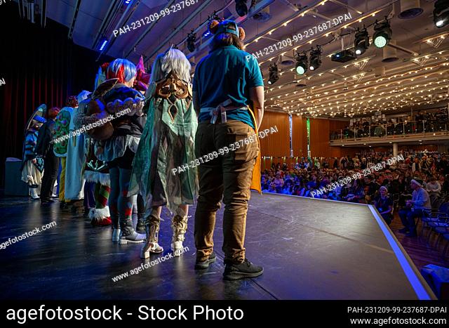 09 December 2023, Bavaria, Coburg: Participants in a costume competition stand side by side on a stage. The German Xmas Con, a trade fair for anime