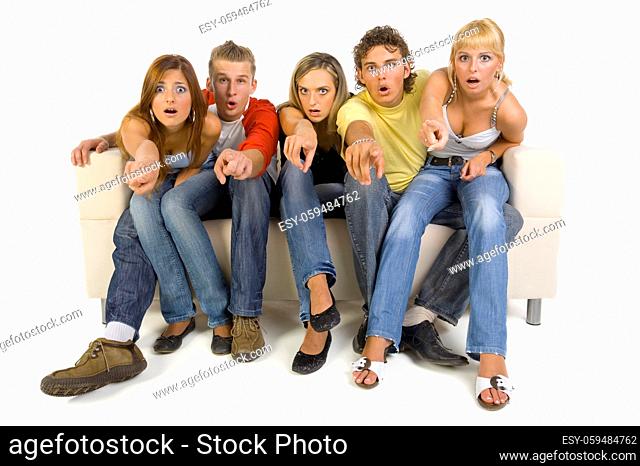 Small group of teenagers sitting on couch. Looking confused. Showing something. Front view, white background