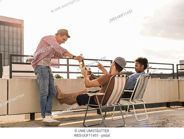 Three friends having a rooftop party