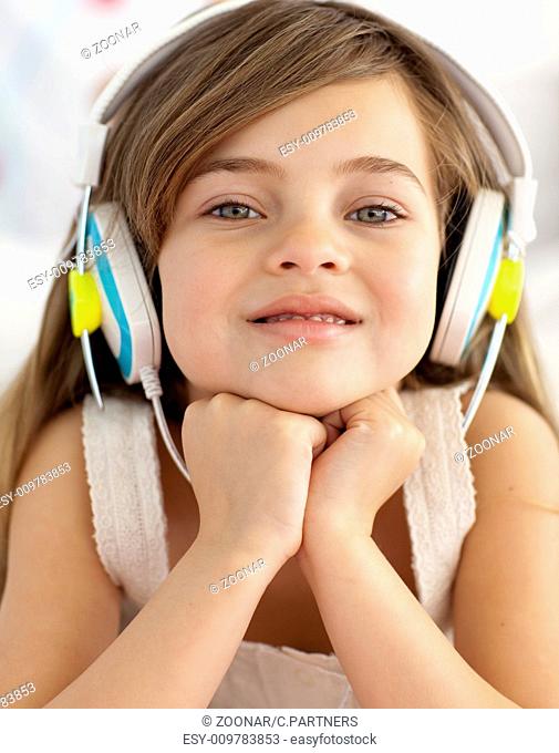 Portrait of little girl listening to the music