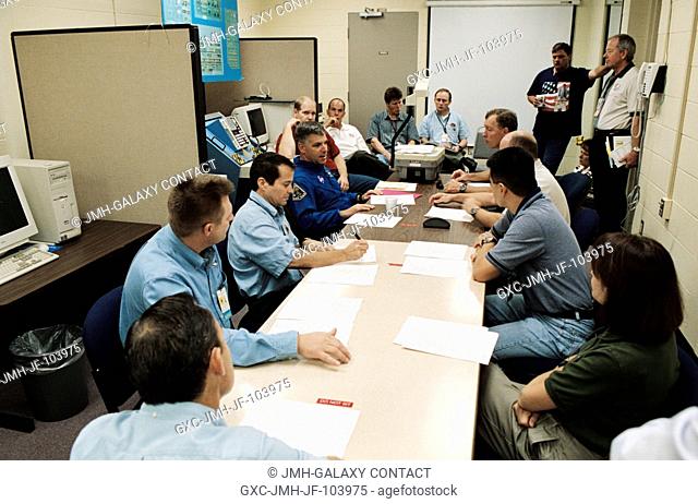 The STS-108 crewmembers and the Expedition Four crew members share a joint planning session in the Space Vehicle Mockup Facility at Johnson Space Center (JSC)