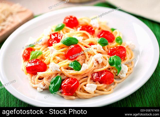 Spaghetti with cherry tomatoes and fresh ricotta on a plate