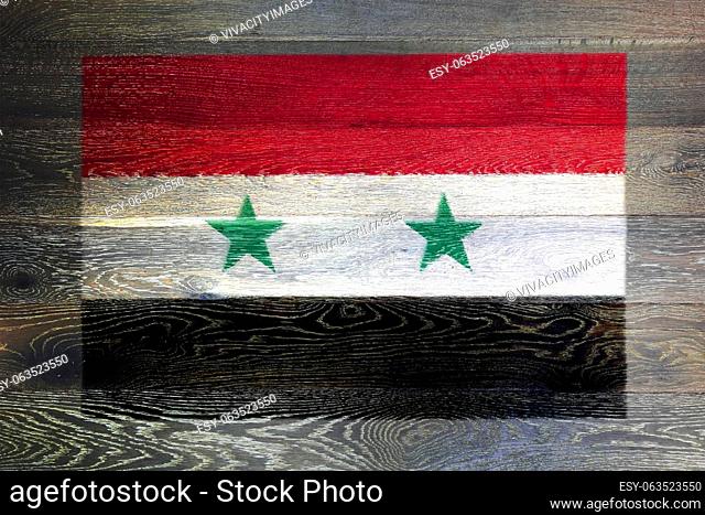 A Syria flag on rustic old wood surface background