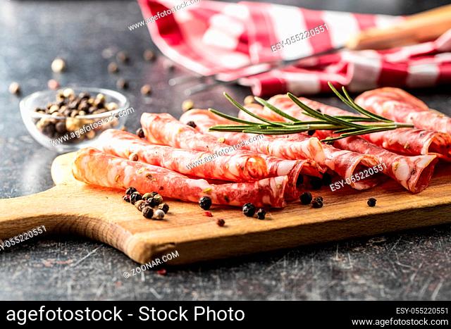 Sliced salami. Sausage meat with pepper and rosemary