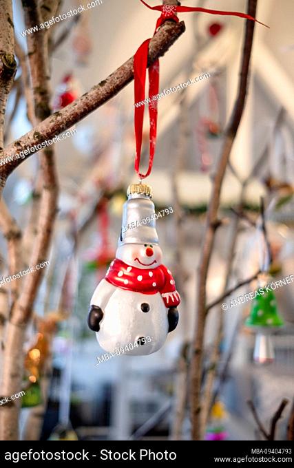 atmospheric Christmas decorations, glass ball, snowman with scarf on birch branch