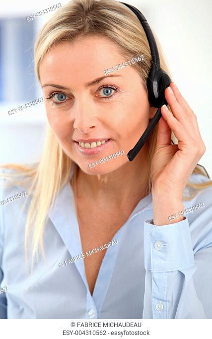 Closeup on blond woman with headset on