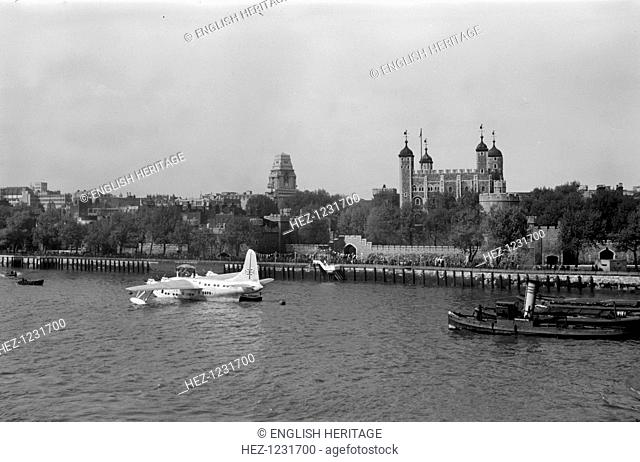 A BOAC Short Sunderland flying boat moored on the River Thames in front of the Tower of London, c1945-c1965. A reception party appears to be gathered on the...