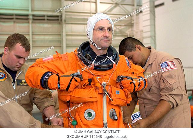 Astronaut Donald R. Pettit, STS-126 mission specialist, dons a training version of his shuttle launch and entry suit in preparation for a training session in...