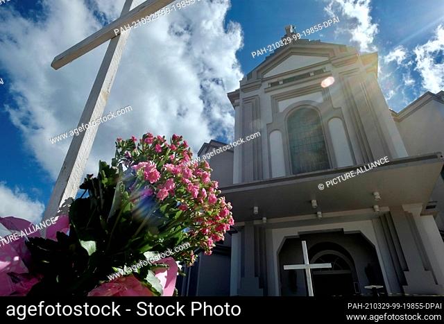 29 March 2021, Brazil, Farroupilha: Crosses stand outside the Nossa Senhora de Caravaggio church during a memorial service for the more than 300