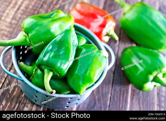 green pepper in metal bowl and on a table