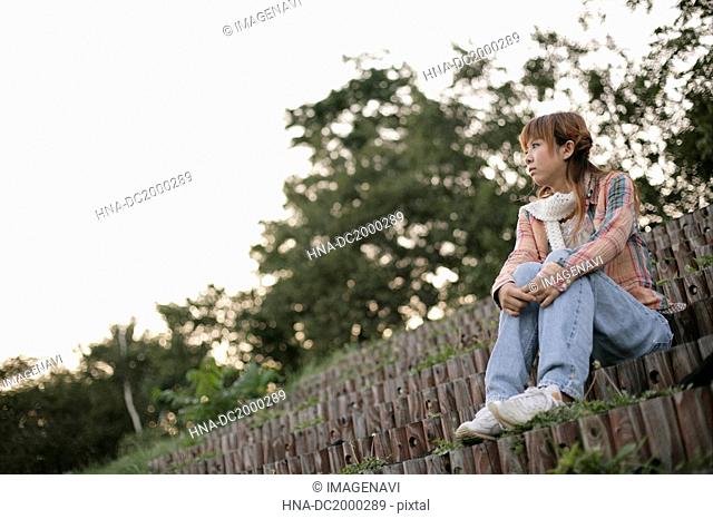 Young woman sitting on stairs