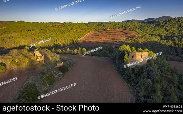 Remains of the ancient castle of Solivella, surrounded by fields at sunset (NavÃ s, Barcelona, Catalonia, Spain)