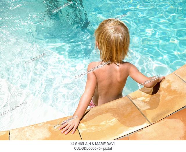 Young boy at ledge of pool