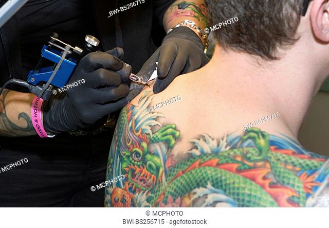 tattooing of a back of a man