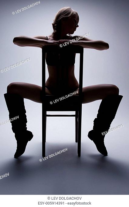 dark picture of sexy woman with chair