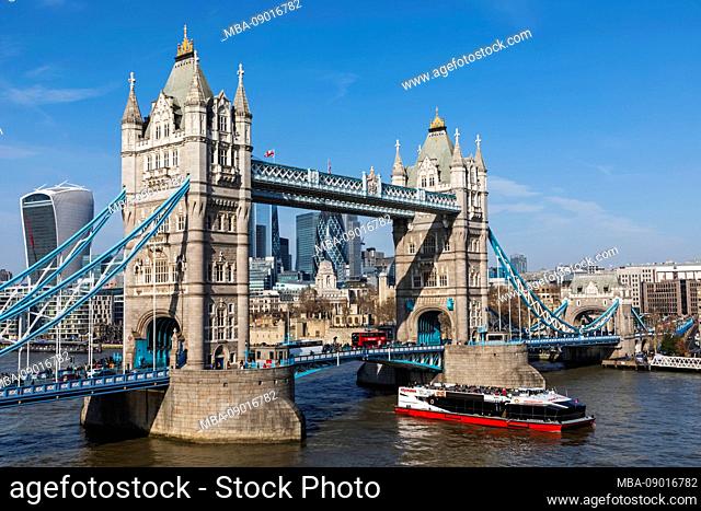 England, London, Tower Bridge and The City of London Skyline with River Tour Boat on The Thames
