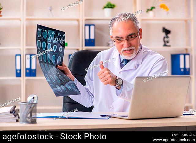 Aged male doctor radiologist in the clinic