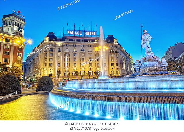 Neptune fountain and the Palace hotel, located at the Paseo del Prado boulevard. Madrid, Spain