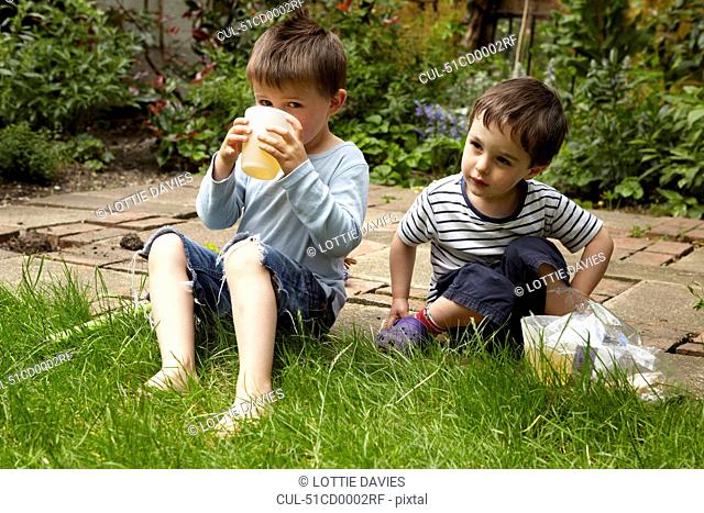 Boys relaxing in garden