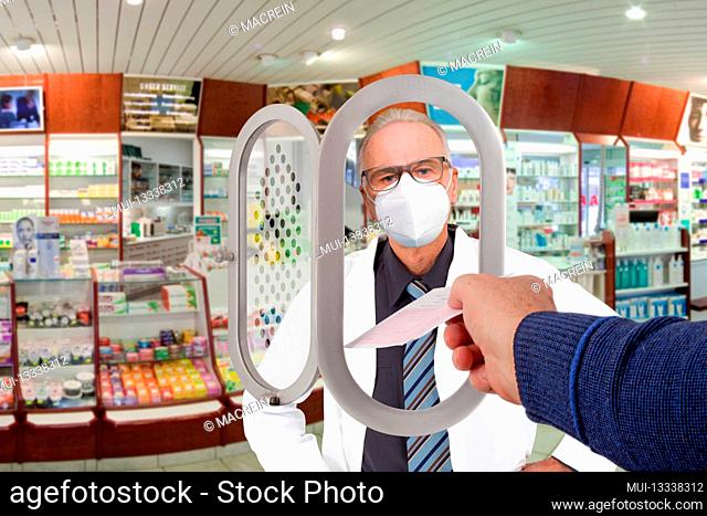 Pharmacist with face mask takes a prescription