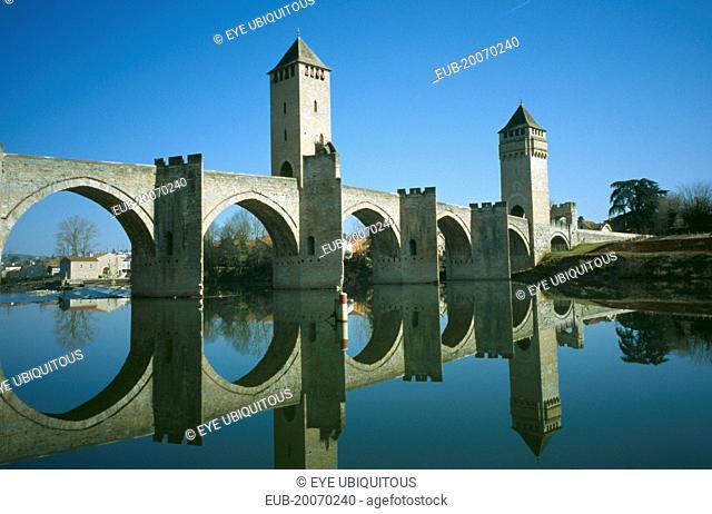 Pont Valentre. Bridge with two towers and it’s reflection in the river