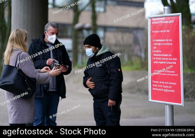 24 November 2021, Hamburg: Employees are checked by a security guard at the entrance to the Otto Group's Otto Campus in accordance with the 3G rules