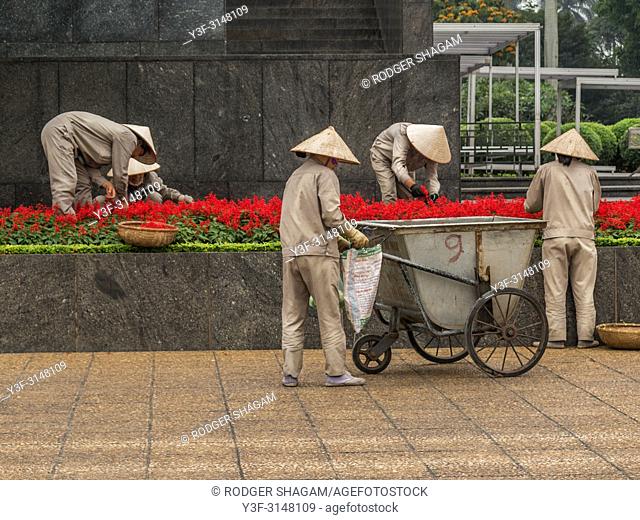 Gardeners working in the gardens in the Ho Chi Minh This style of hat is used primarily as protection from the sun and rain