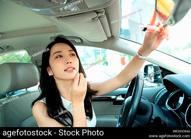 Young women makeup in the car